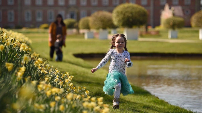 Visitors in the garden in spring at Erddig, Wrexham, Wales